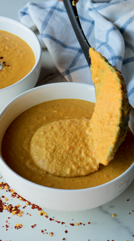 To make this creamy red lentil soup, begin by sautéing onions and minced garlic in oil. Then add carrots and seasonings. Cook for a few minutes, then add tomato paste, red lentils, and water. Bring to a boil, then cover and cook on super low for 30 minutes, or until lentils and carrots are soft. Blend until smooth, then add heavy cream. Add more heavy cream if a more soupy consistency is desired. Top with red pepper flakes and cilantro and enjoy!